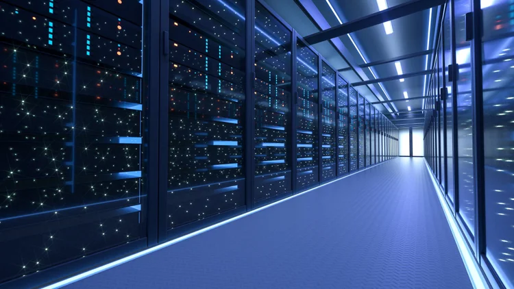 Rows of illuminated server racks inside a modern data center